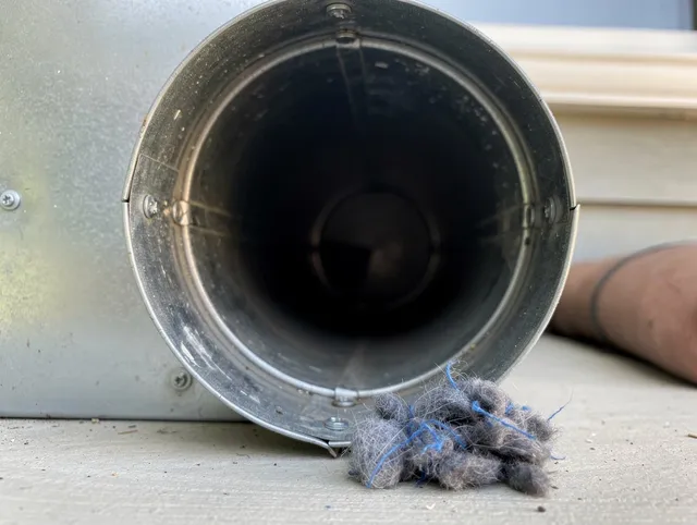 Sudbury Dryer Vent Cleaning technician using specialized equipment to clear severe dryer vent blockage in Sudbury